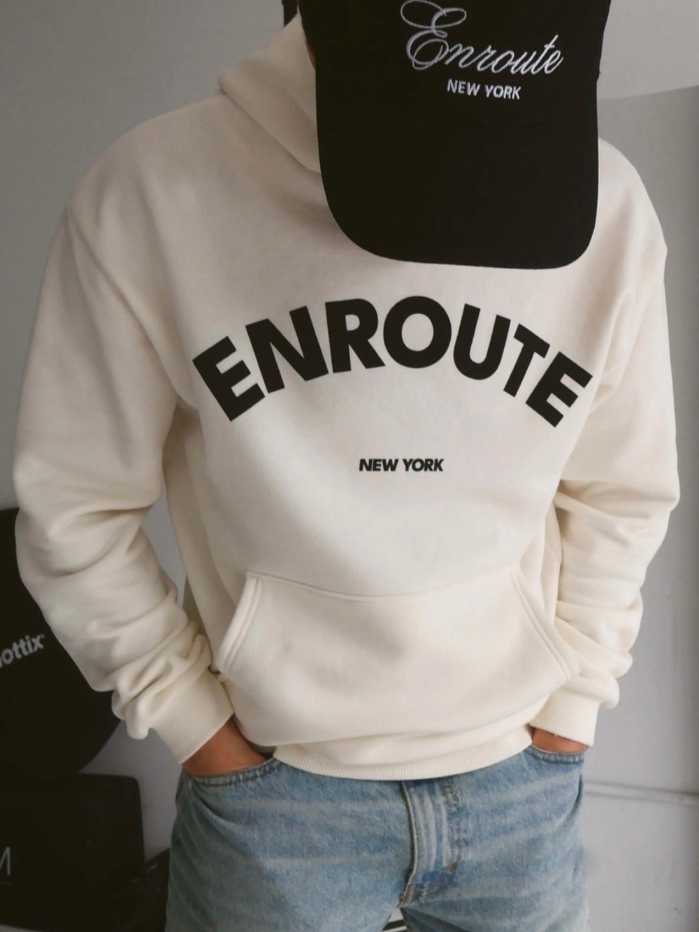 ENROUTE cream-colored crew-neck sweatshirt.